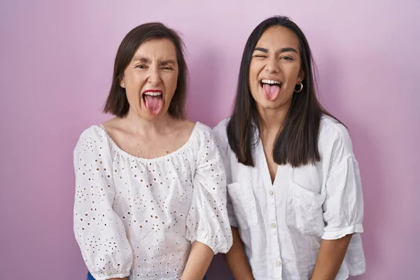 Hispanic Mother Daughter Together Sticking Tongue Out Happy Funny Expression — Stock Photo, Image
