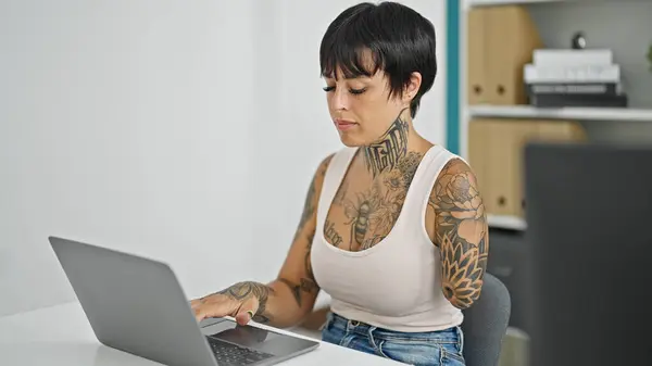 Hispanic woman with amputee arm business worker using laptop working at the office