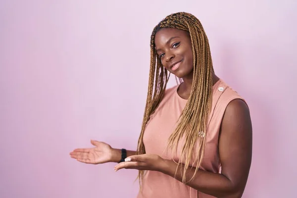 African American Woman Braided Hair Standing Pink Background Inviting Enter — Fotografia de Stock