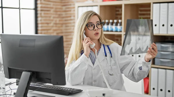 Young Blonde Woman Doctor Talking Telephone Holding Xray Clinic —  Fotos de Stock