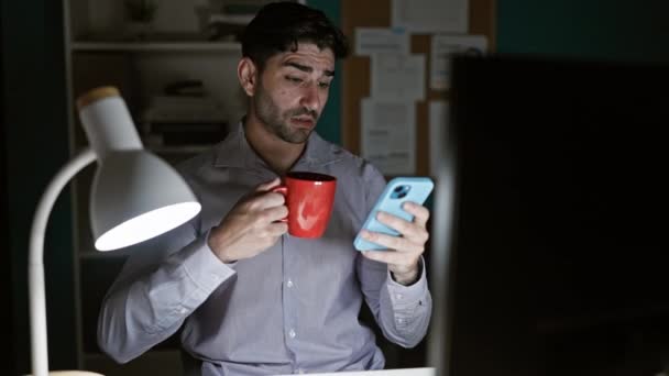 Trabajador Negocios Joven Hispano Usando Teléfono Inteligente Bebiendo Café Oficina — Vídeos de Stock