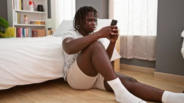 Afrikanischer Mann Sitzt Gestresst Mit Smartphone Schlafzimmer Auf Dem Boden — Stockvideo