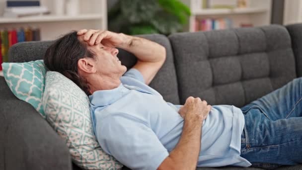 Homem Meia Idade Sofrendo Dor Cabeça Deitado Sofá Casa — Vídeo de Stock