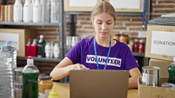Joven Mujer Rubia Voluntaria Utilizando Ordenador Portátil Verificación Productos Centro — Vídeos de Stock