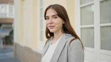 Sokakta kendinden emin gülümseyen genç İspanyol kadın.