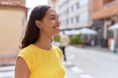 Young african american woman smiling confident looking to the side at street