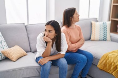 Two women mother and daughter arguing at home