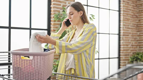 Young Blonde Woman Talking Smartphone Hanging Clothes Clothesline Laundry Room — Fotografia de Stock