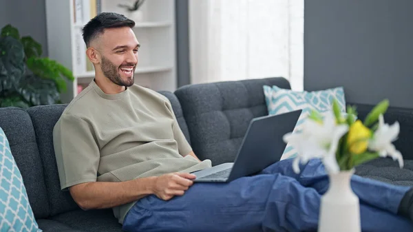 Young Hispanic Man Using Laptop Sitting Sofa Home — стоковое фото