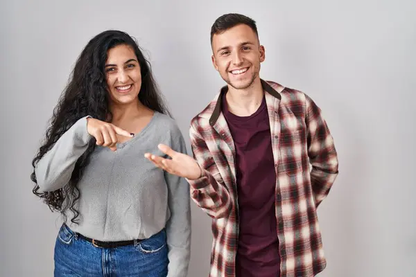 Young Hispanic Couple Standing White Background Amazed Smiling Camera While — Stock Photo, Image