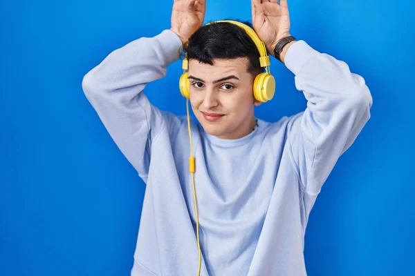 Non Binary Person Listening Music Using Headphones Doing Bunny Ears — Stock Photo, Image