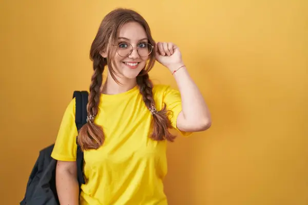 Young Caucasian Woman Wearing Student Backpack Yellow Background Smiling Pointing — Stock Photo, Image