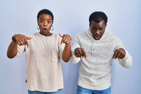 Young African American Couple Standing Blue Background Together Pointing Fingers — Stock Photo, Image