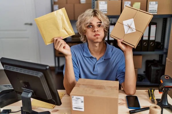 Young Man Working Small Business Ecommerce Holding Packages Puffing Cheeks — Stock Photo, Image