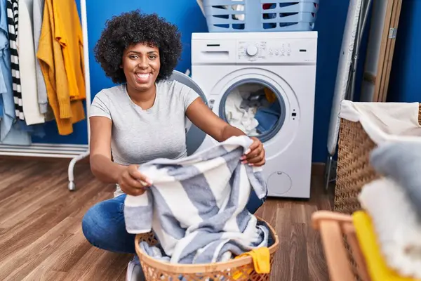 African American Woman Smiling Confident Washing Clothes Laundry Room — Fotografia de Stock