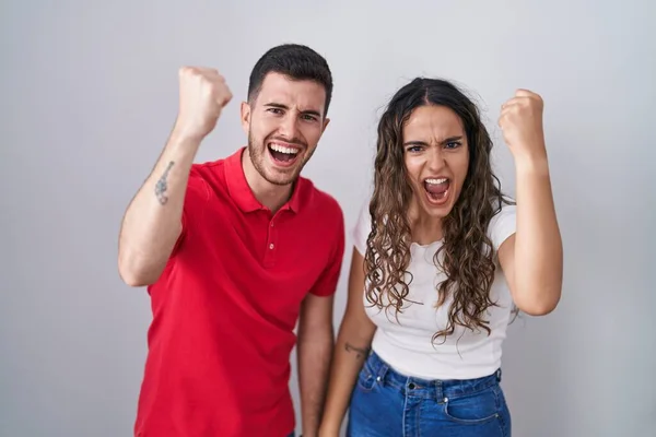 Young Hispanic Couple Standing Isolated Background Angry Mad Raising Fist — Stock Photo, Image