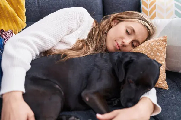 Young Blonde Woman Lying Sofa Sleeping Dog Home — Stockfoto