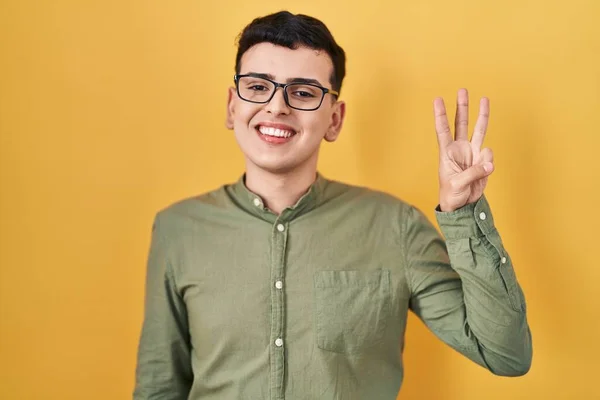 Non Binary Person Standing Yellow Background Showing Pointing Fingers Number — Stock Photo, Image