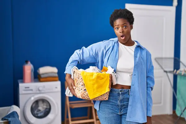 African American Woman Holding Laundry Basket Scared Amazed Open Mouth — Foto Stock
