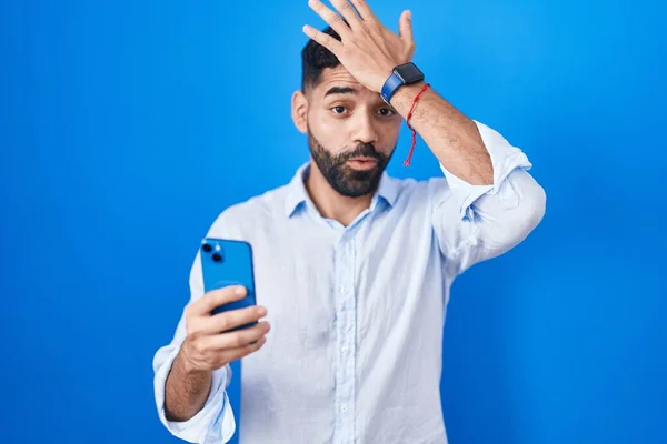 Hispanic Man Beard Using Smartphone Typing Message Surprised Hand Head — Stock Photo, Image