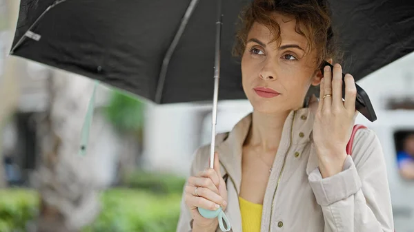 Young Woman Listening Voice Message Holding Umbrella Street — Stock Photo, Image