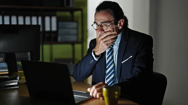 Middle age man business worker stressed using laptop at the office
