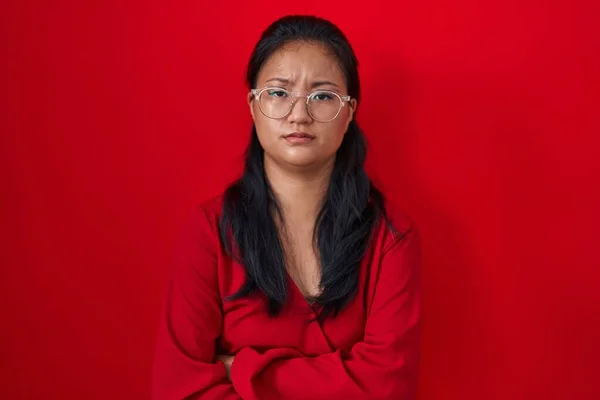 Asiatisk Ung Kvinna Står Över Röd Bakgrund Skeptisk Och Nervös — Stockfoto