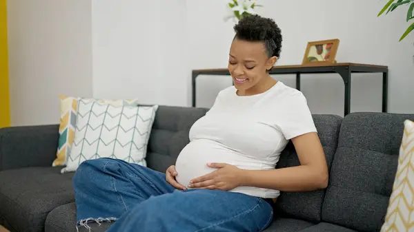 Young Pregnant Woman Touching Belly Sitting Sofa Home — Fotografia de Stock