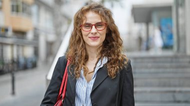 Young woman business worker smiling confident at street