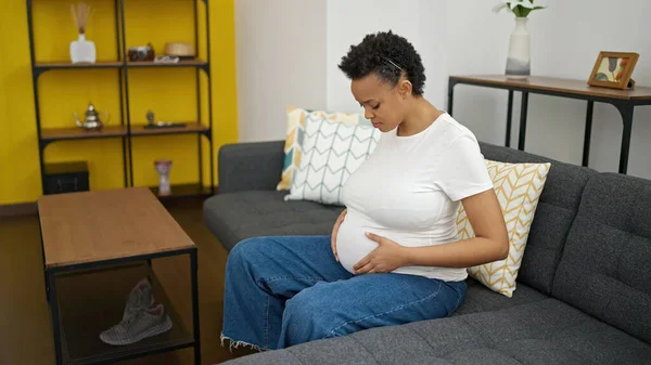 Young Pregnant Woman Touching Belly Sitting Sofa Sad Expression Home — Stock Photo, Image