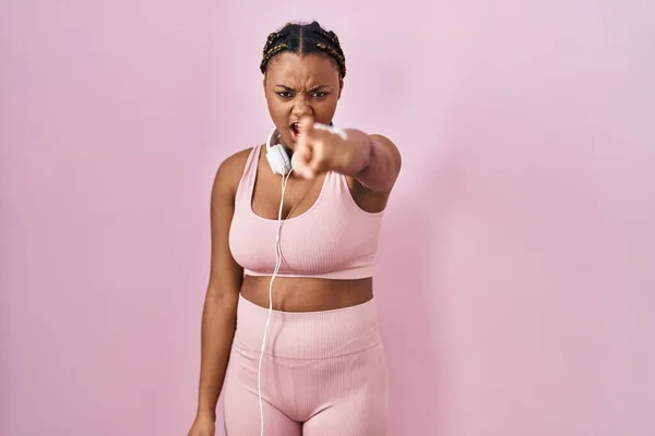 African American Woman Braids Wearing Sportswear Headphones Pointing Displeased Frustrated —  Fotos de Stock