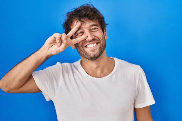 Hispanic Young Man Standing Blue Background Doing Peace Symbol Fingers — 图库照片