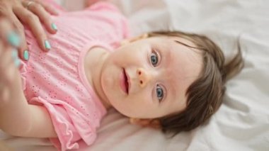 Anne ve kızı yatak odasında uzanıyorlar.