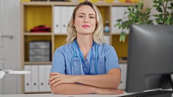 Young Blonde Woman Doctor Smiling Confident Sitting Table Clinic — Video Stock