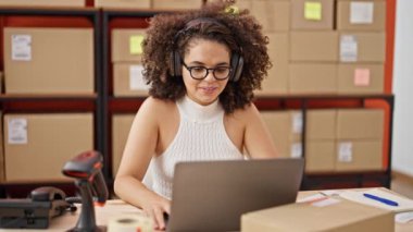 Young beautiful hispanic woman ecommerce business worker having video call at office