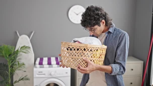 Young Hispanic Man Holding Basket Smelling Clothes Laundry Room — Stock Video