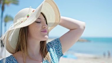 Genç sarışın turist. Deniz kenarında kendine güvenen bir gülümseme.