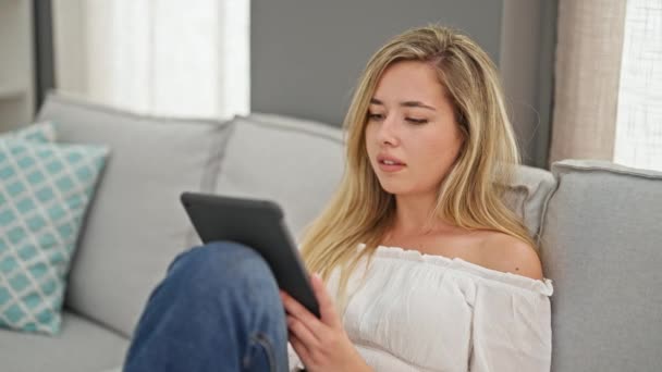 Young Blonde Woman Using Touchpad Sitting Sofa Home — Stock video