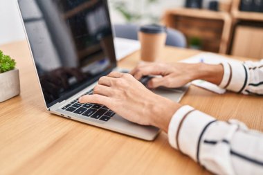 Young hispanic man business worker using laptop working at office