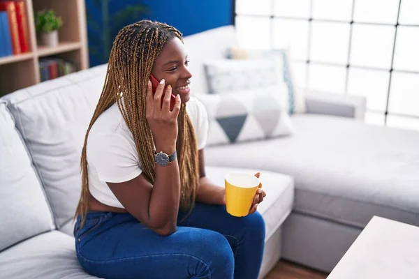 African American Woman Talking Smartphone Drinking Coffee Home — Stock Photo, Image