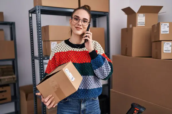 Young Woman Ecommerce Business Worker Holding Package Talking Smartphone Office — Fotografia de Stock