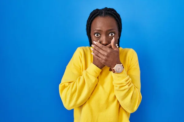 Beautiful Black Woman Standing Blue Background Shocked Covering Mouth Hands — Stock Photo, Image