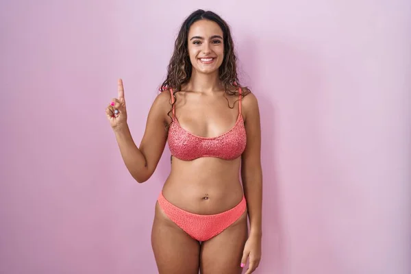 Young Hispanic Woman Wearing Lingerie Pink Background Showing Pointing Finger — Stock Photo, Image