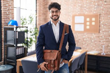 Young hispanic man business worker smiling confident standing at office