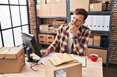 Young man ecommerce business worker tired working at office