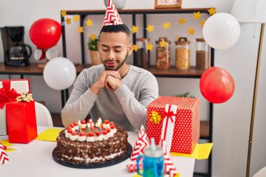 African american man having wishing celebrating birthday at home