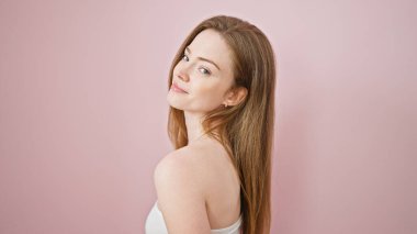 Young blonde woman smiling confident standing over isolated pink background