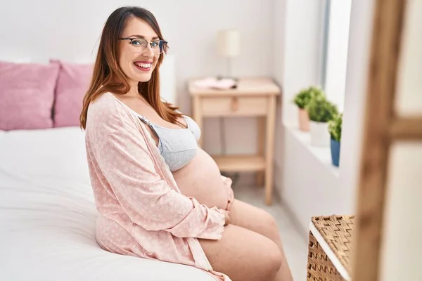 Young Pregnant Woman Touching Belly Sitting Bed Bedroom — Stock fotografie