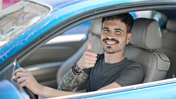 Young Hispanic Man Driving Car Doing Gesture Thumb Street — Stock fotografie