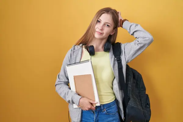 Young Caucasian Woman Wearing Student Backpack Holding Books Confuse Wondering — Stockfoto